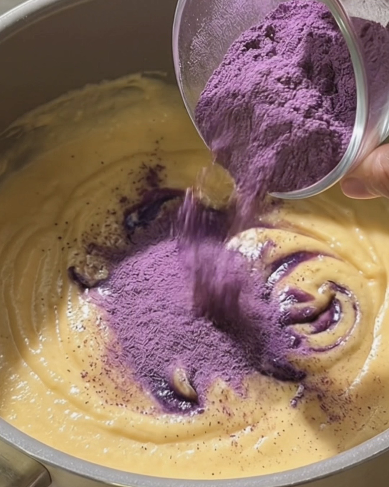 Incorporare con una frusta l'polvere di ube Ube Nolia nel latte di cocco e condensato per fare il ripieno di ube halaya per dadar gulung