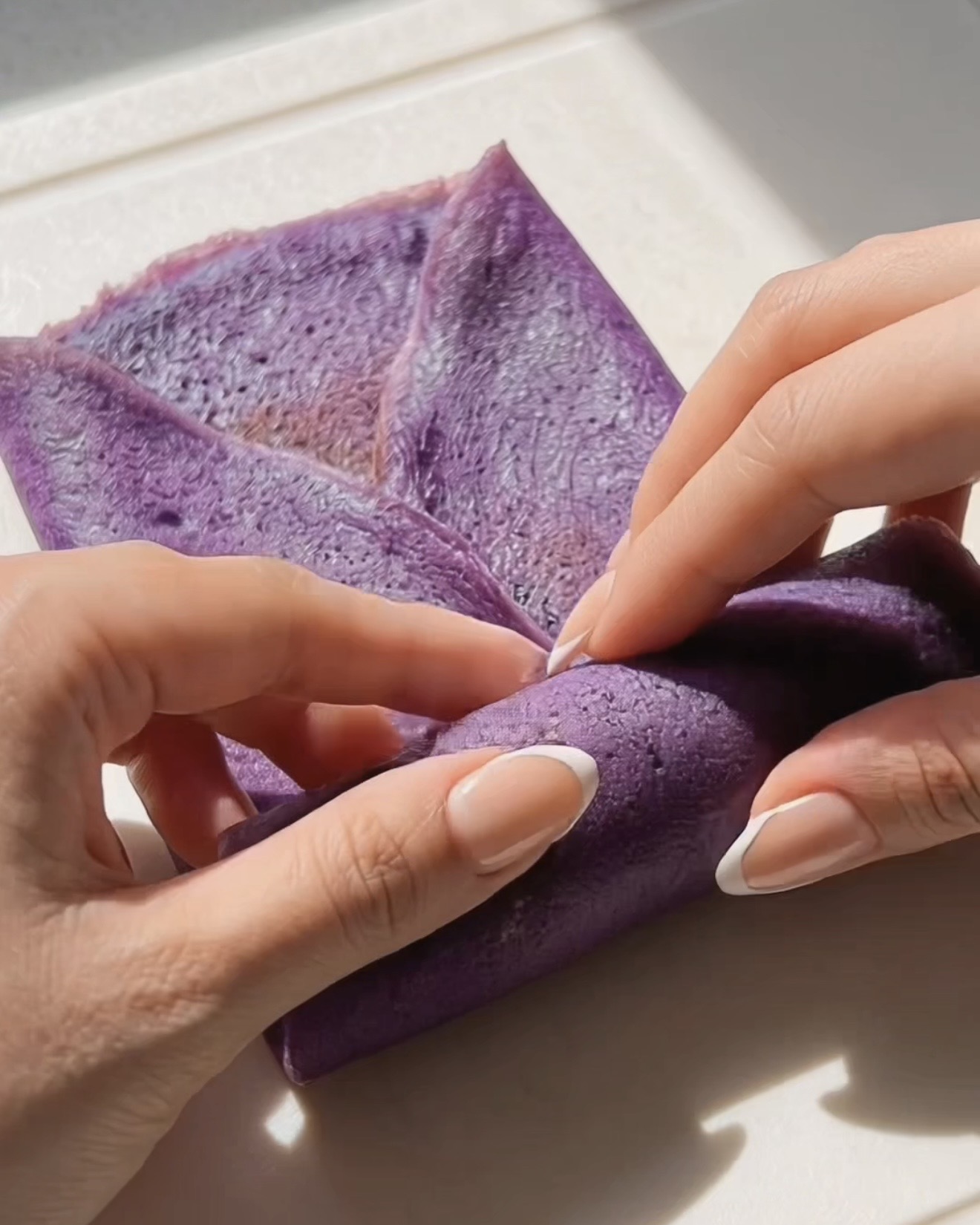 Arrotolare a busta una crepe ube dadar gulung attorno al ripieno di ube halaya viola